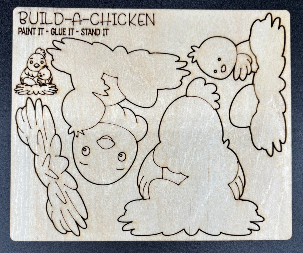 A wooden craft kit piece labeled 'BUILD-A-CHICKEN' with engraved outlines of a chicken and its parts, shown on a dark background.